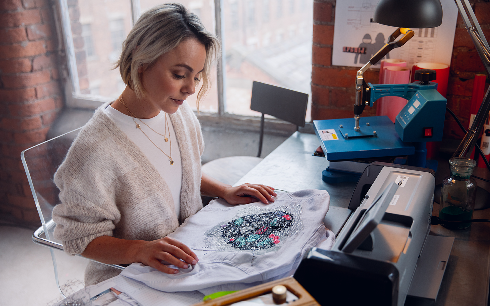 woman looks at embroidered jacket with ScanNCut