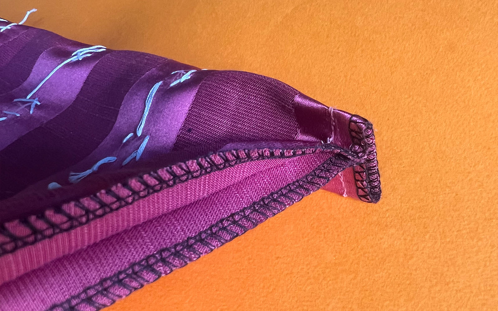 Overlocked sides of pink makeup bag