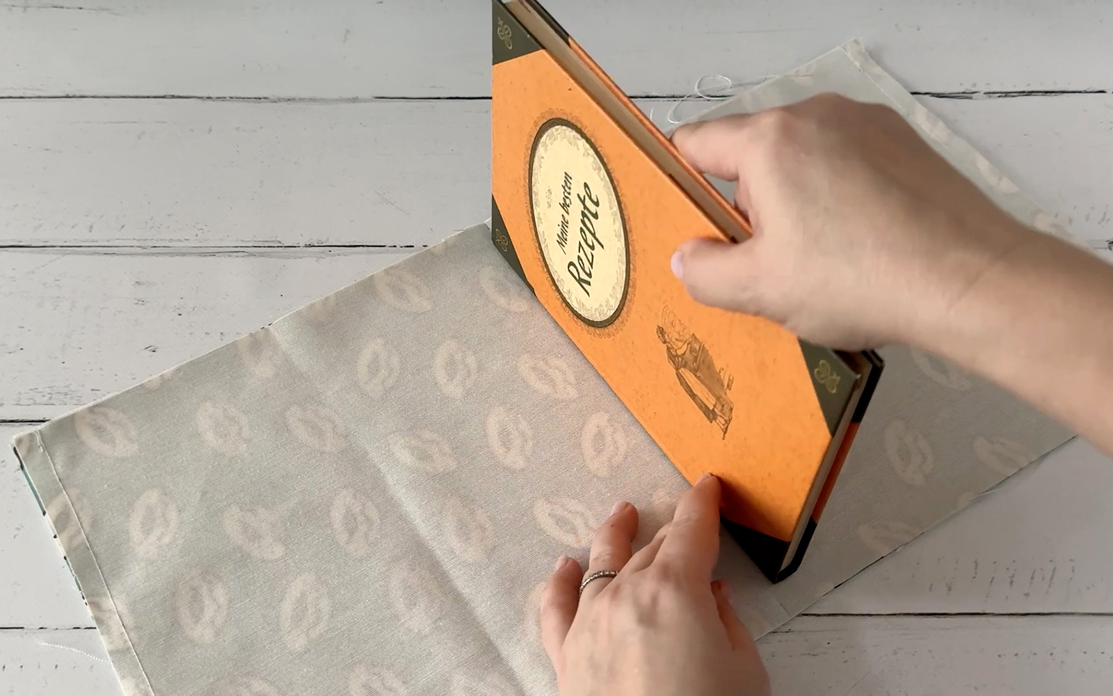 Book laid on fabric to find centre.