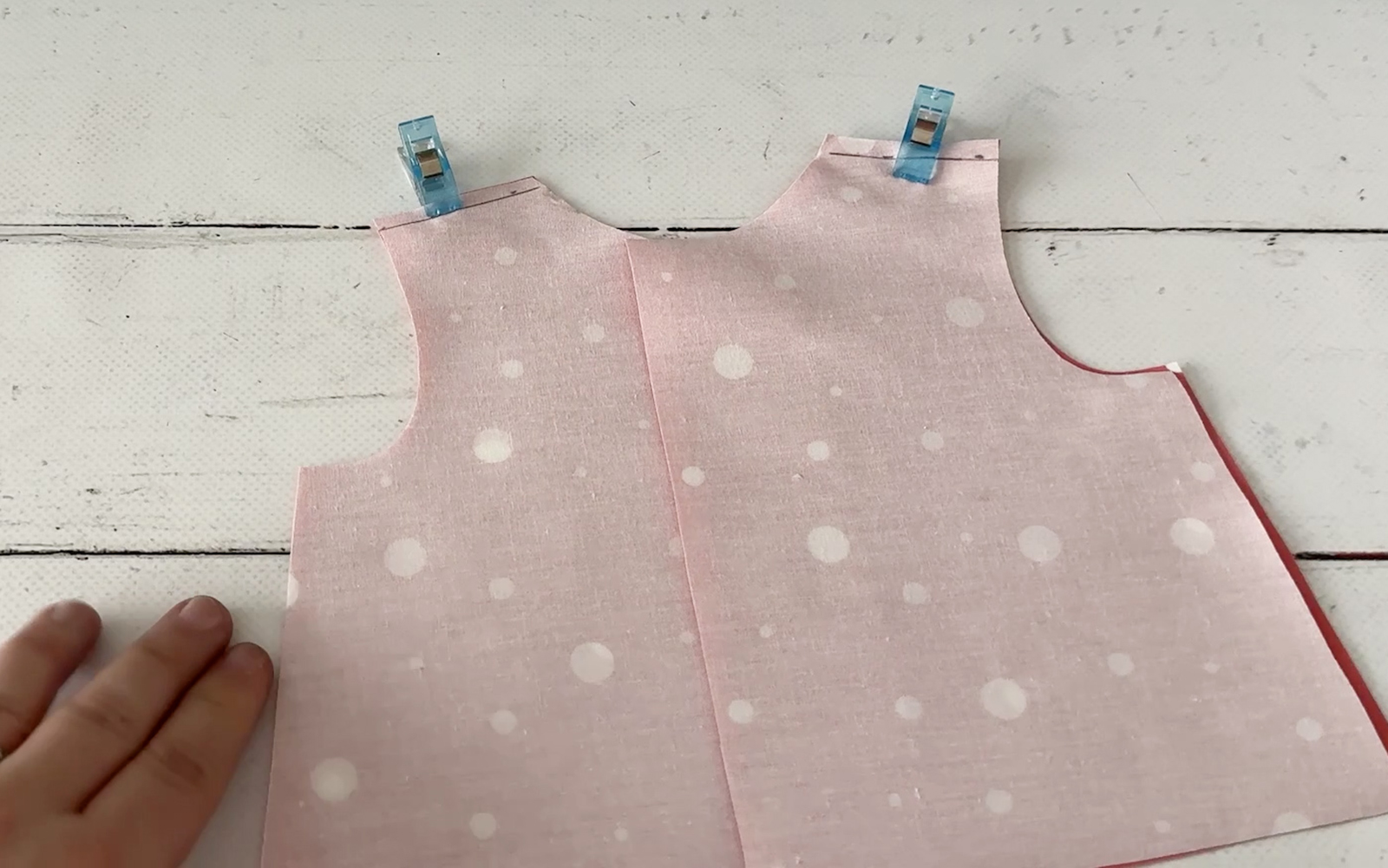 Sewing shoulder seams on doll’s shirt.