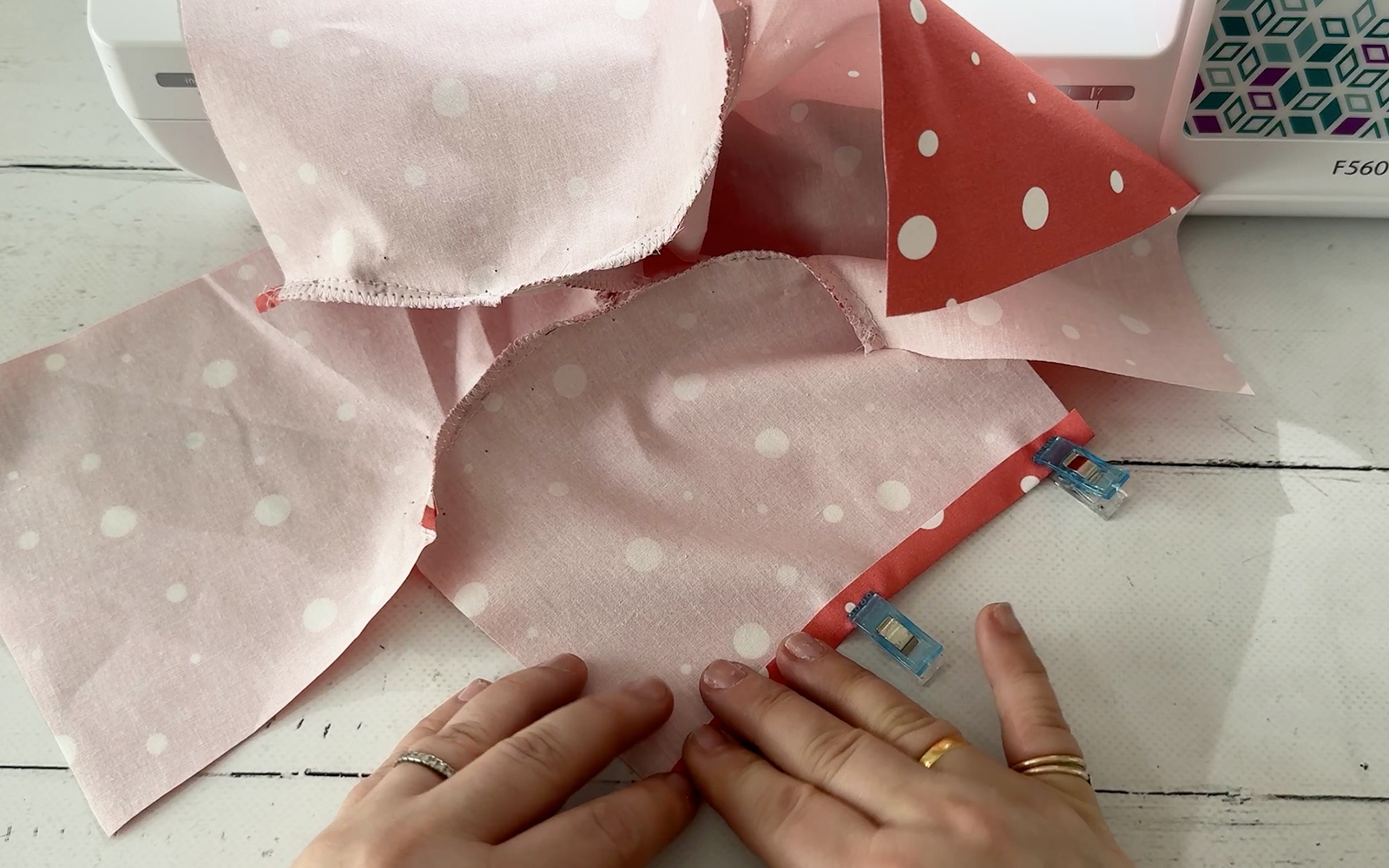 Folding hems into the ends of sleeves of doll’s shirt.