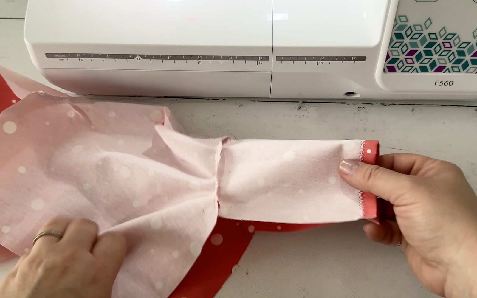 Placing sleeve and side seams on doll’s shirt.