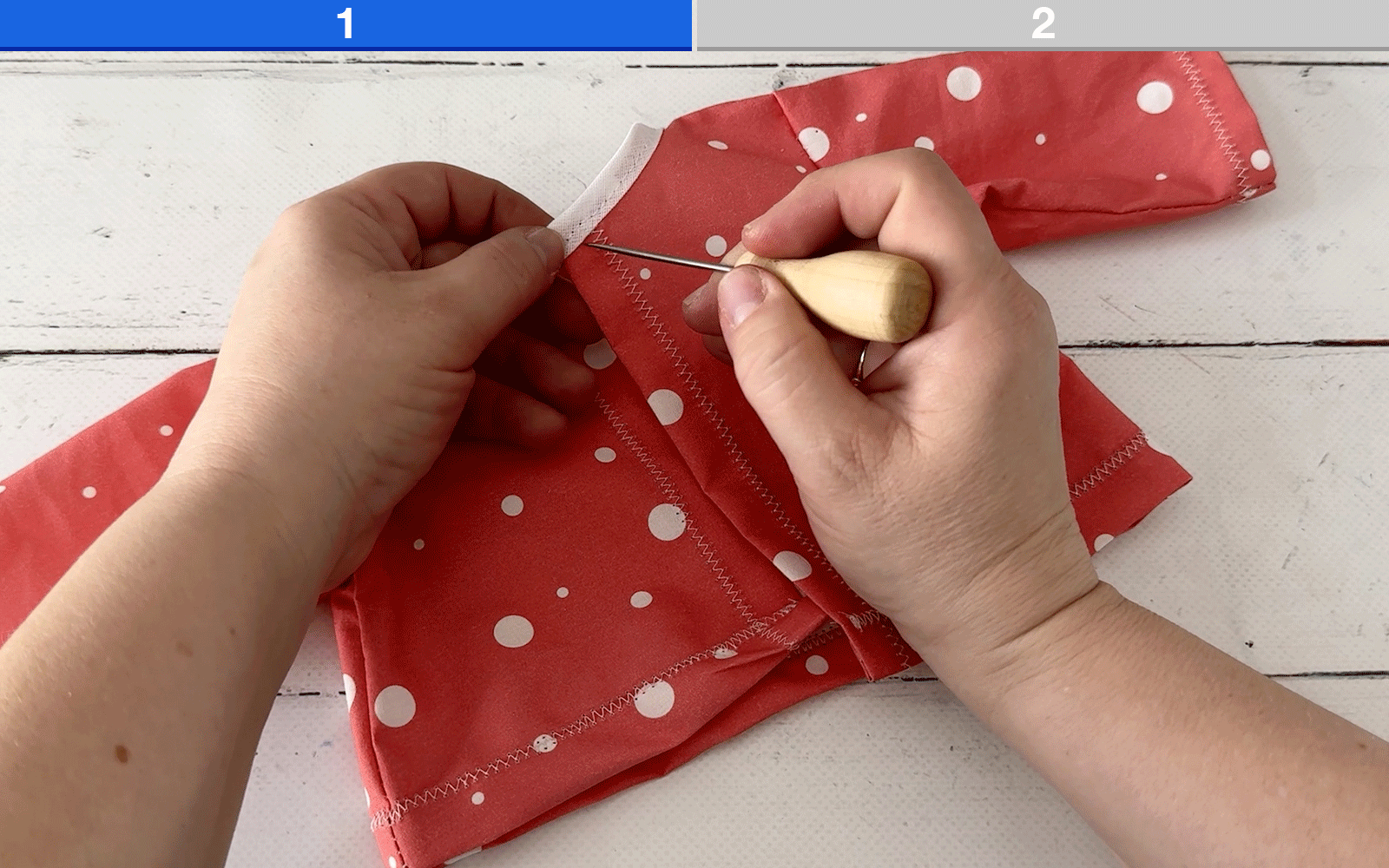 Inserting snap fasteners into doll’s shirt back