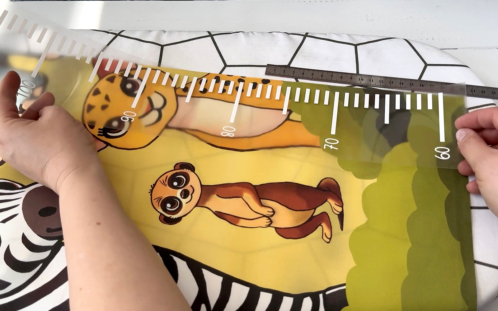 Placing vinyl scale cut on ScanNCut onto jungle height chart