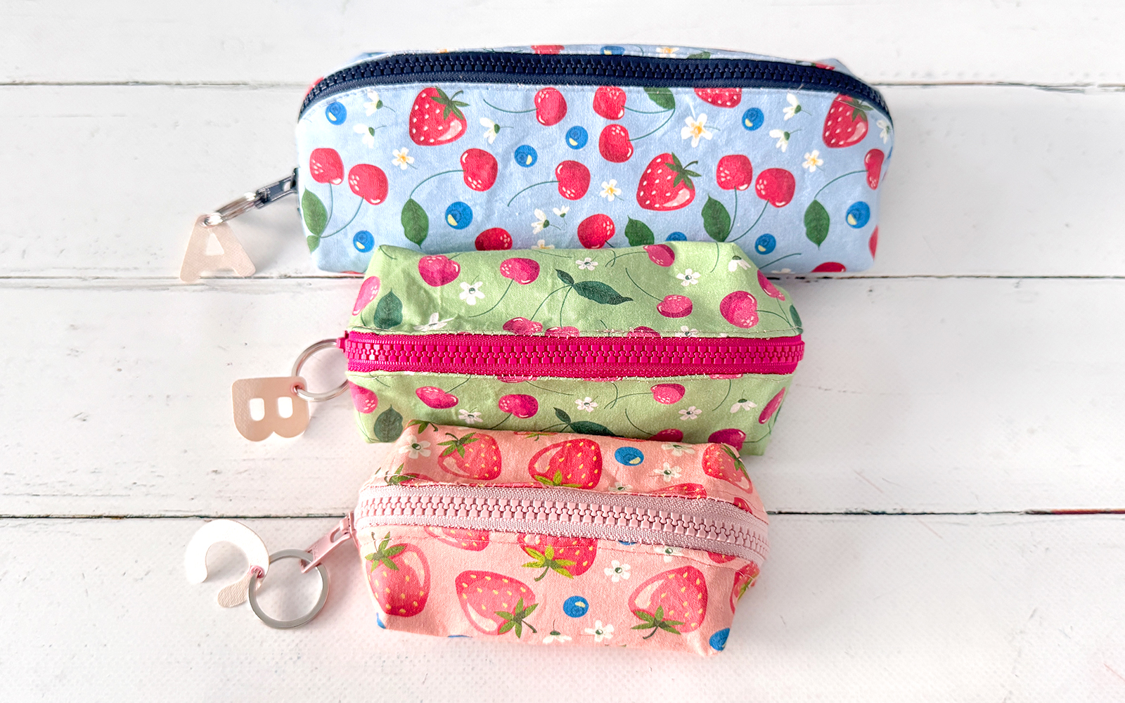 Three sizes of pencil cases with fruit patterns