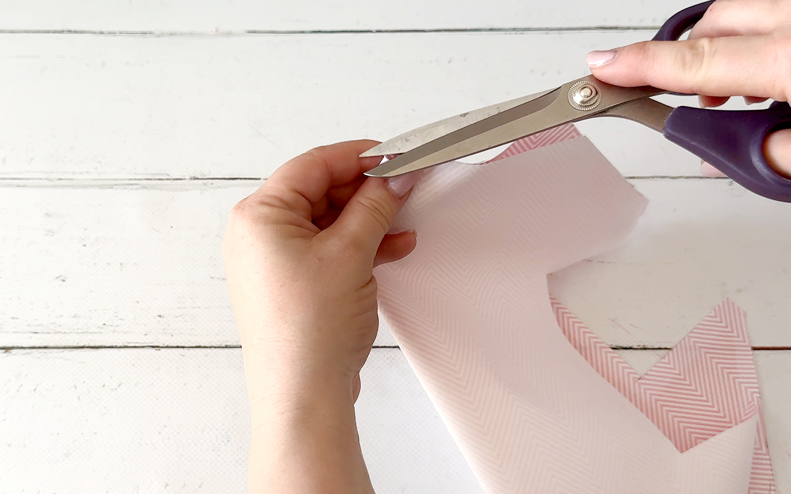 Cutting a snip to mark the centre of lining fabric.
