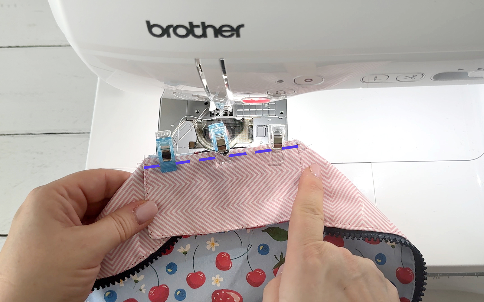 Sewing the pencil case flap to the seam.