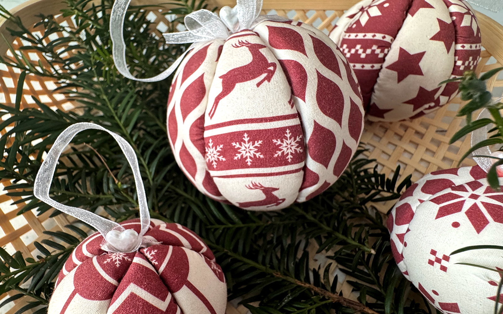 Wicker basket with red and white fabric Xmas baubles 