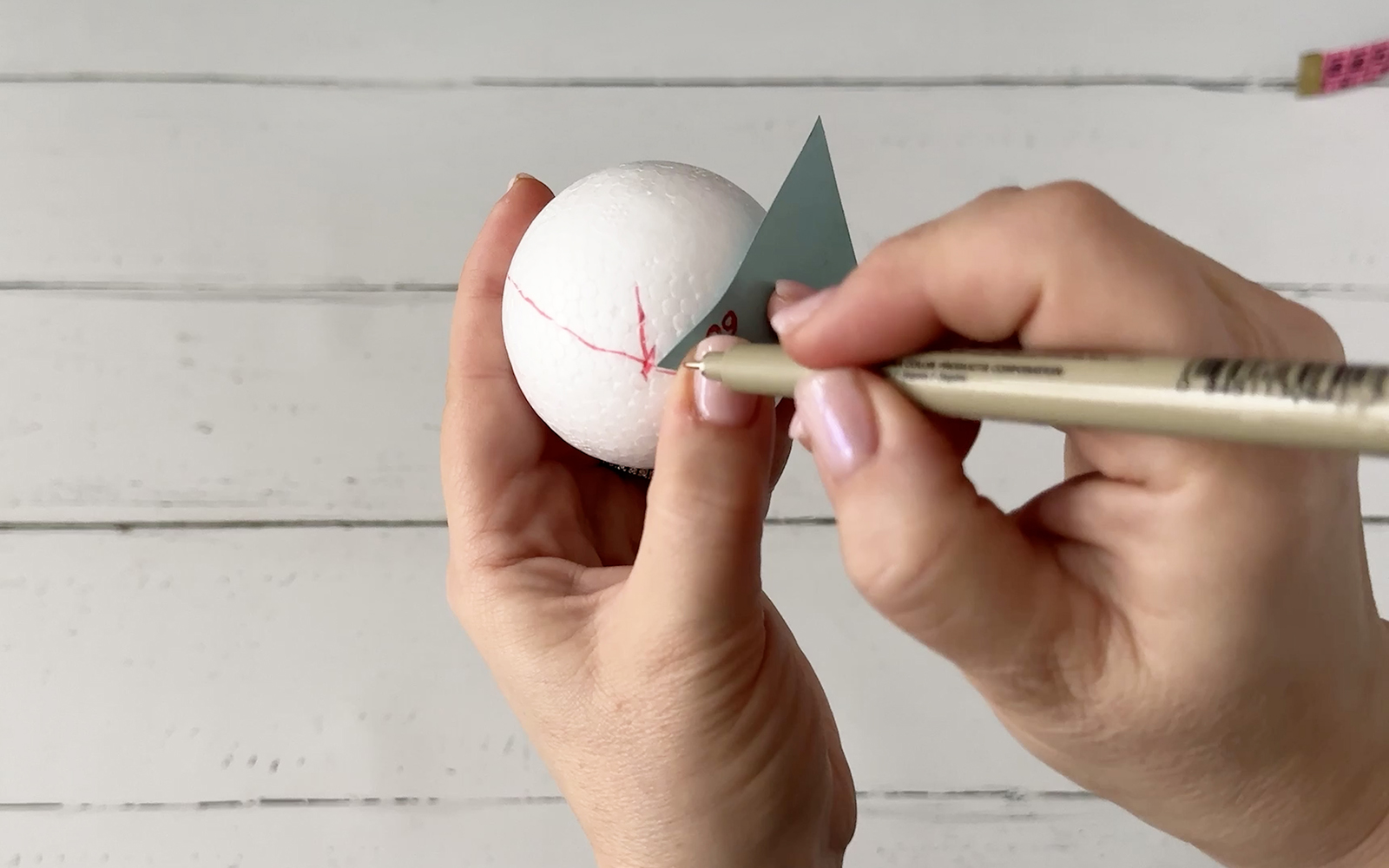 Pen marks the angle on the Styrofoam ball