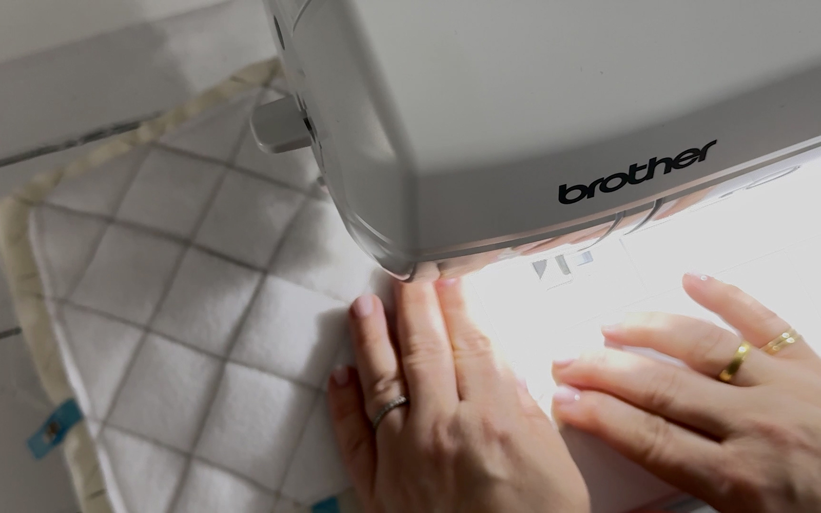 Brother machine sewing around edges of potholder