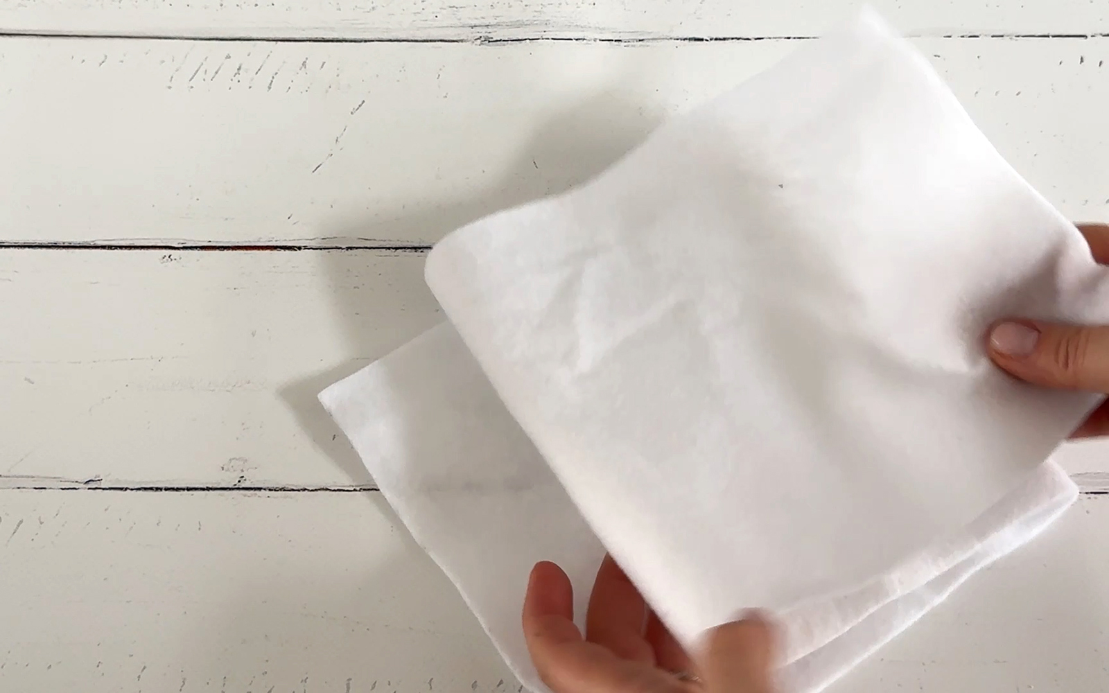 white batting being folded into three pieces