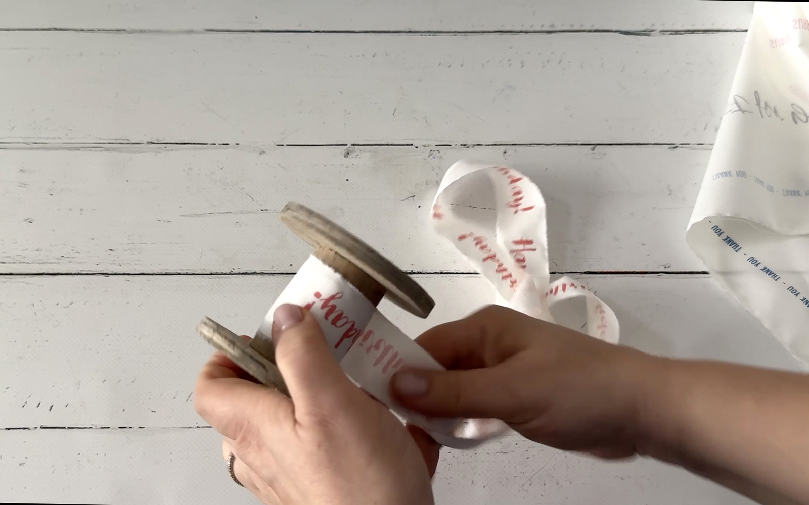 Winding gift ribbons around a wooden bobbin
