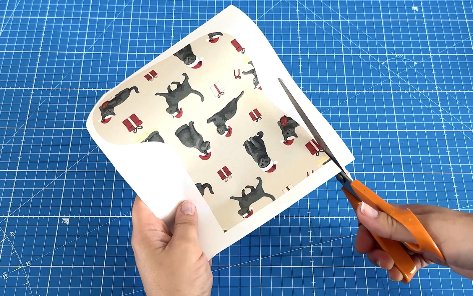 Scissors cutting stocking shape from printed fabric