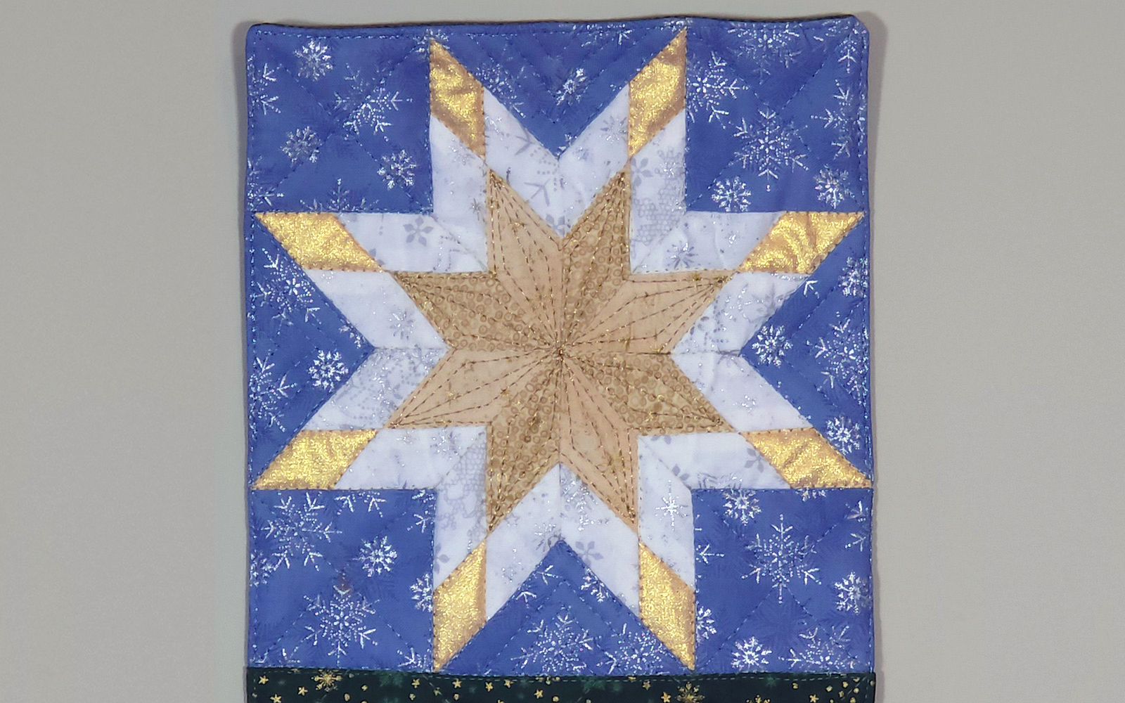 Blue, white and gold lone star quilted block.