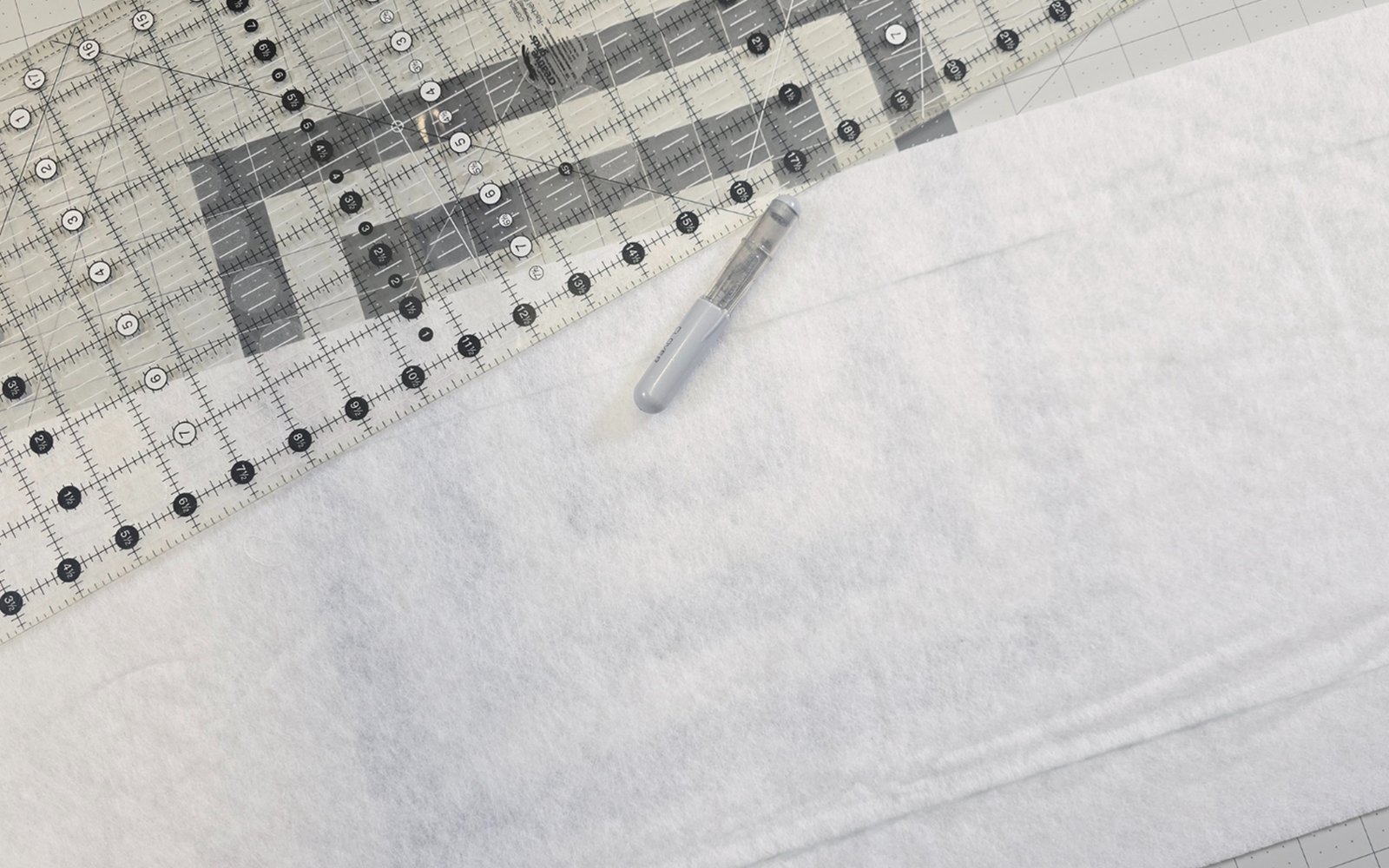 white quilt batting with quilt ruler.