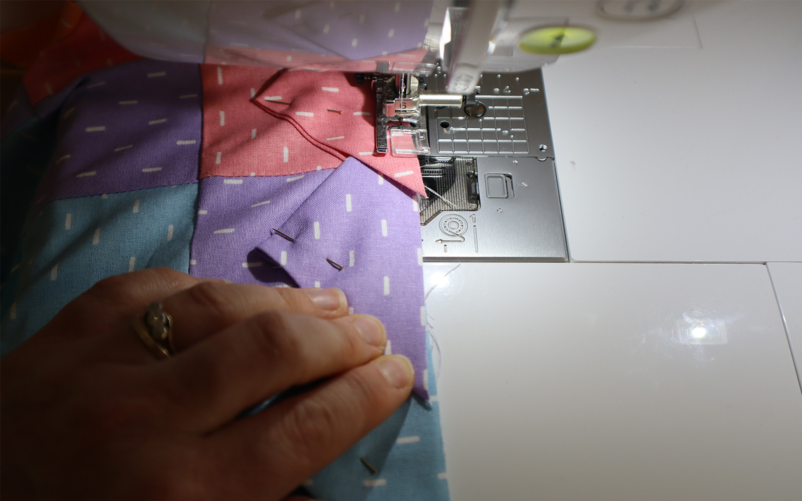 Triangles being stitched to the edge of the square fabric