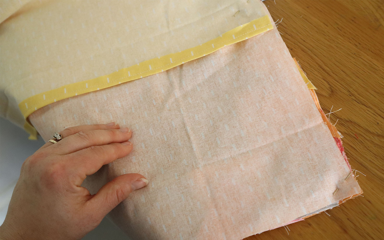 Fabric pieces right sides together on brown table
