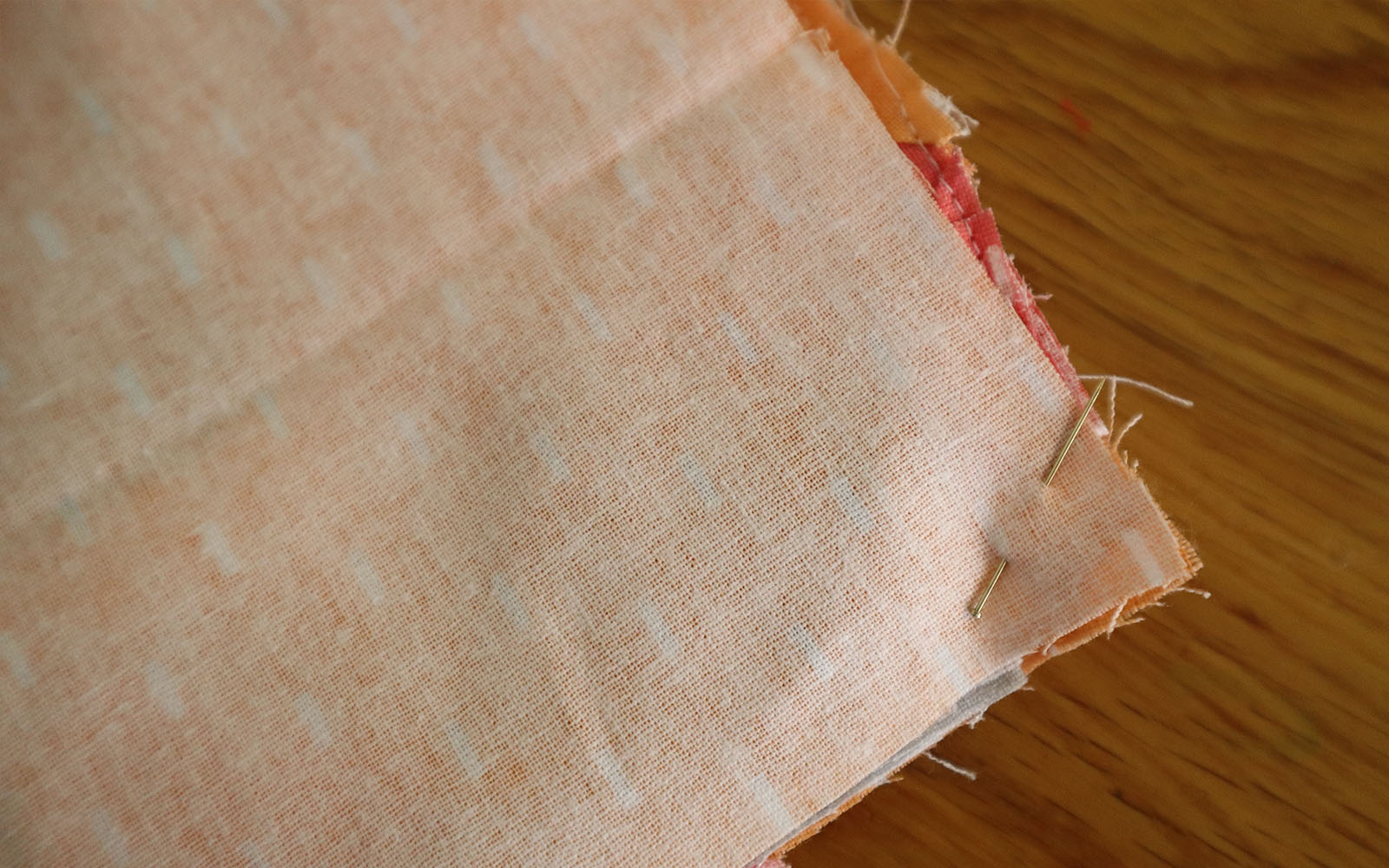 Fabric pinned in corner on brown table