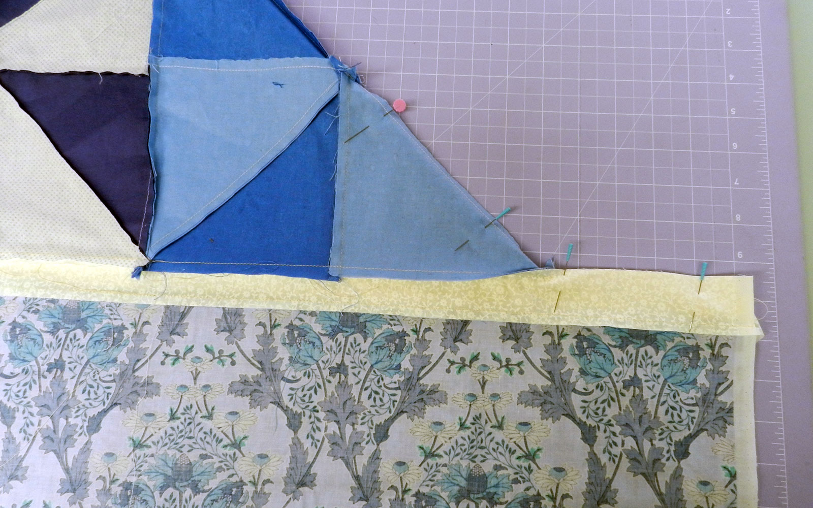 different quilt pieces attached with needles