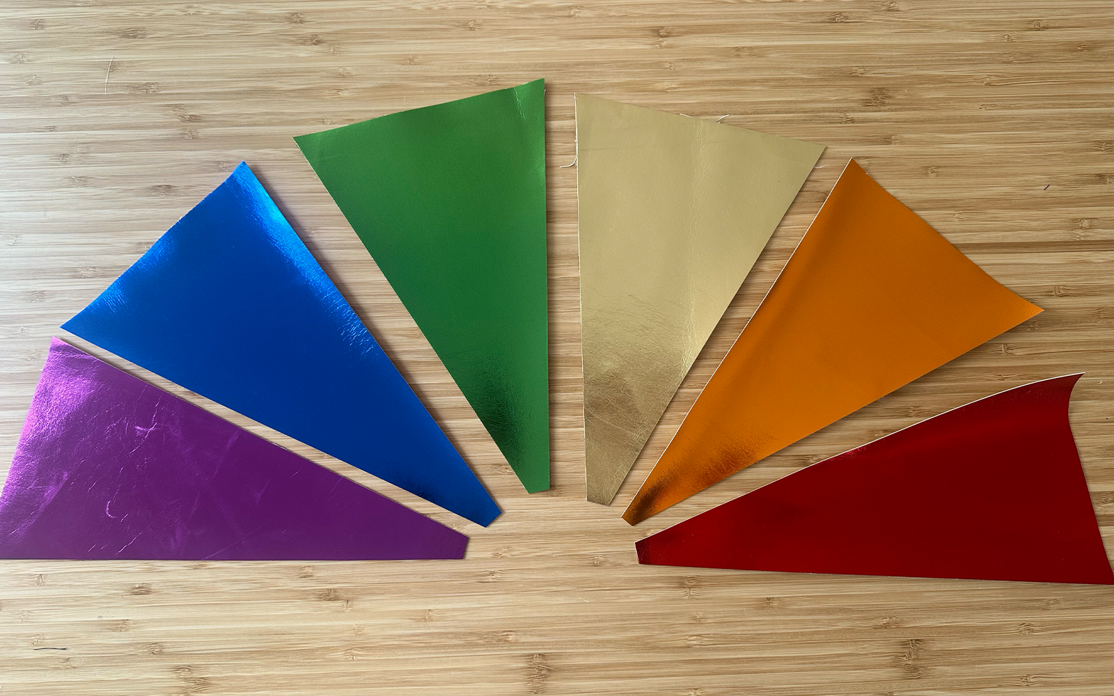 Triangle rainbow pleather pieces arranged in fan shape