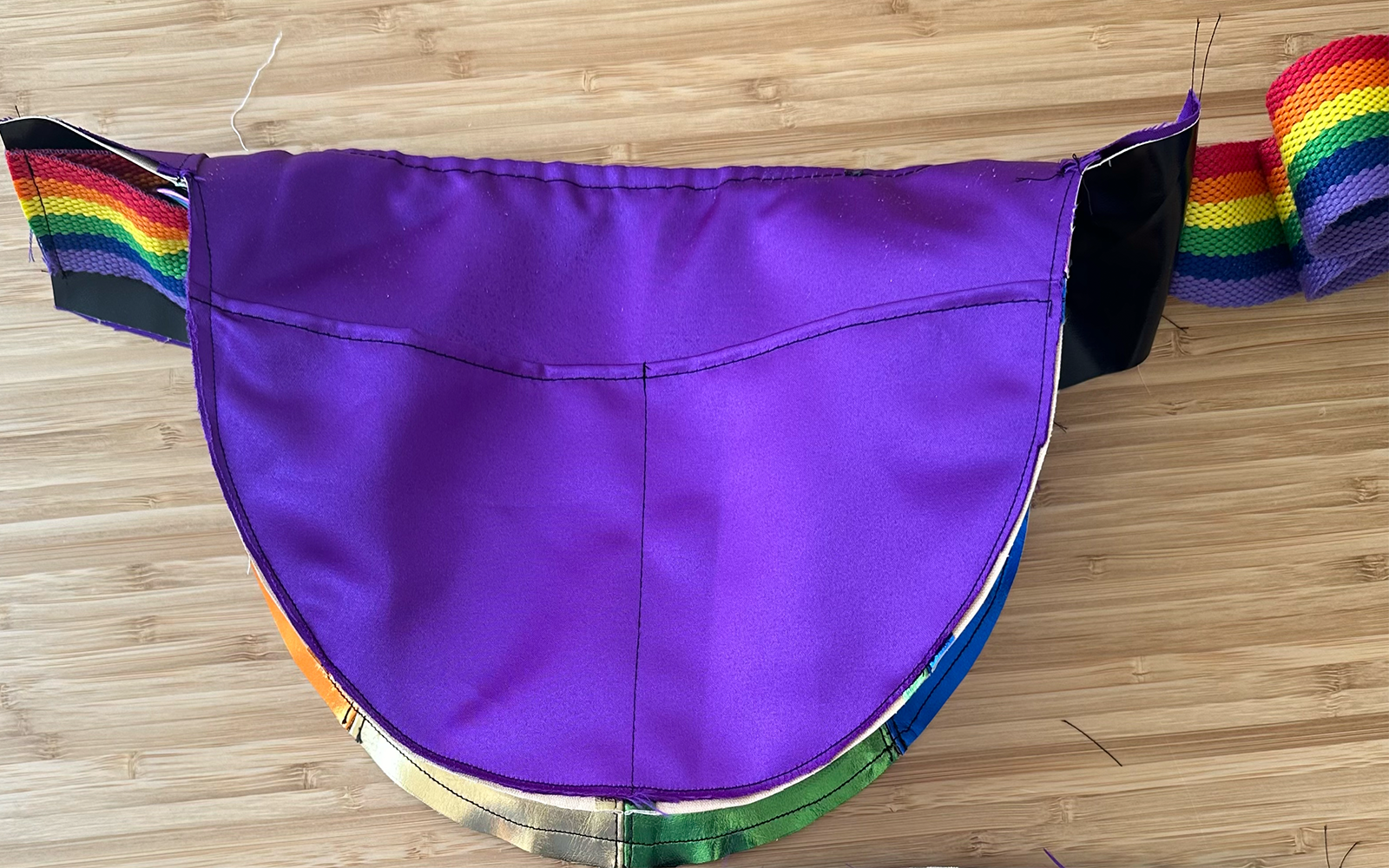 close up showing internal pocket in purple satin inside shoulder bag