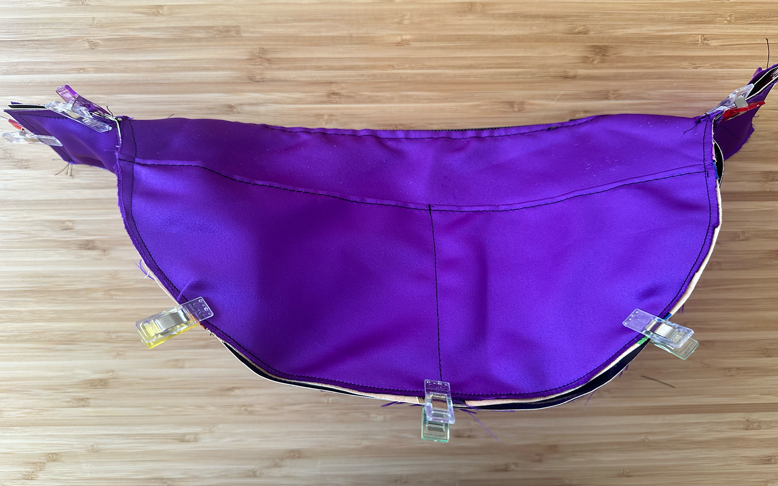 purple inside of shoulder bag with sewing clips holding together