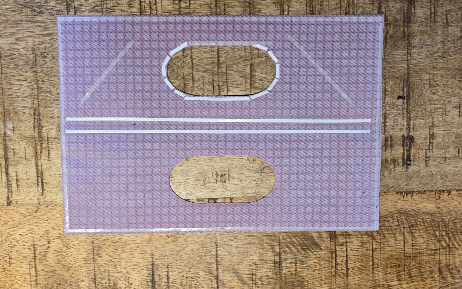 White basting tape on purple vinyl handbag handle panel