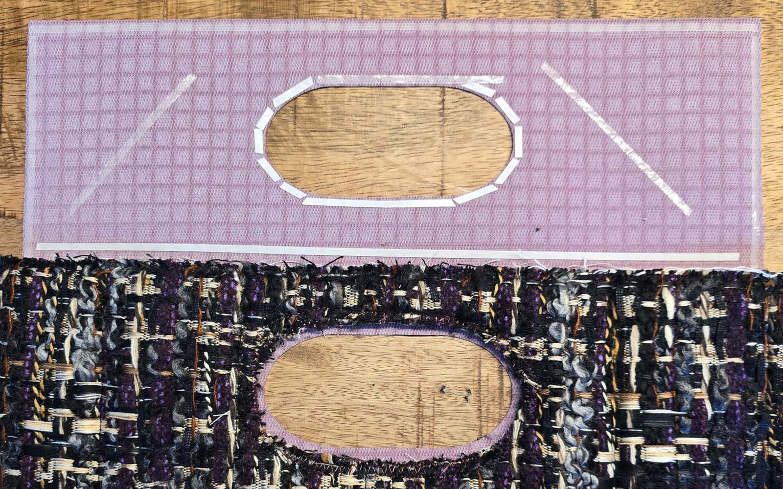 Purple vinyl handbag handle on black fabric