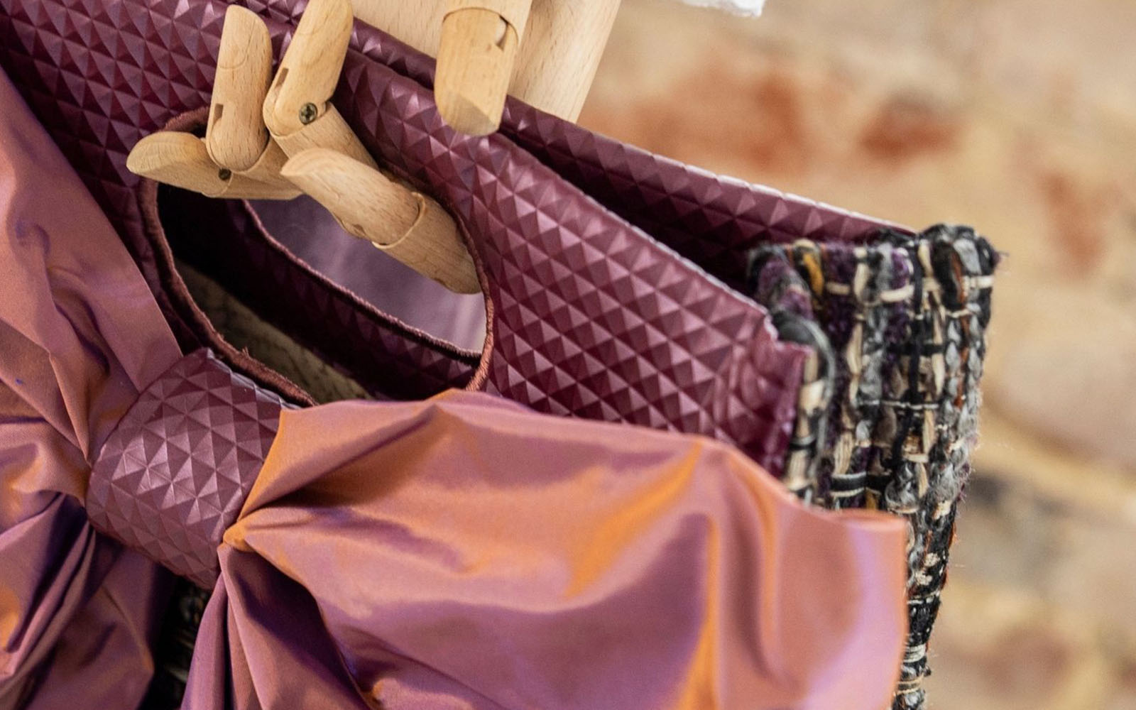 Close up of corners sewn on black and purple handbag
