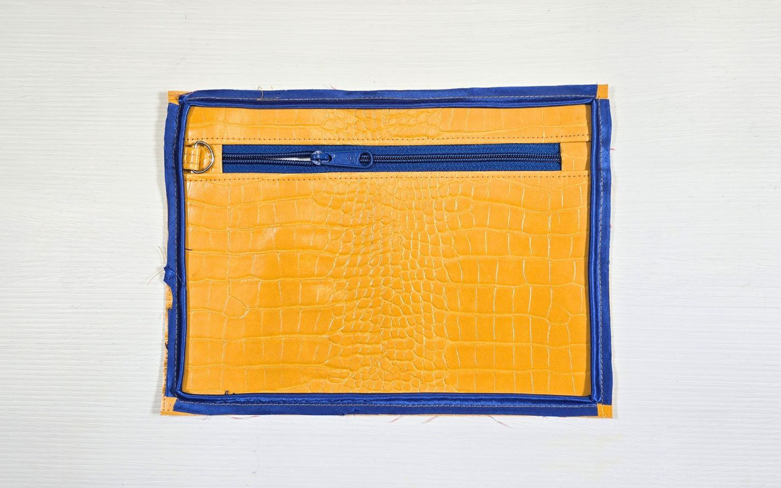 Yellow pleather bag with blue piping basted on