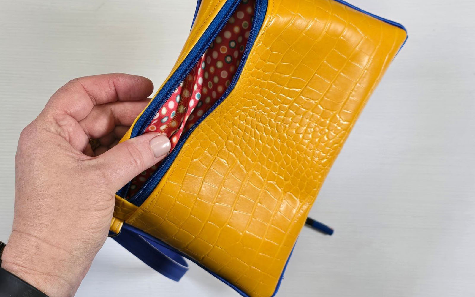 Red lining showing on yellow clutch bag