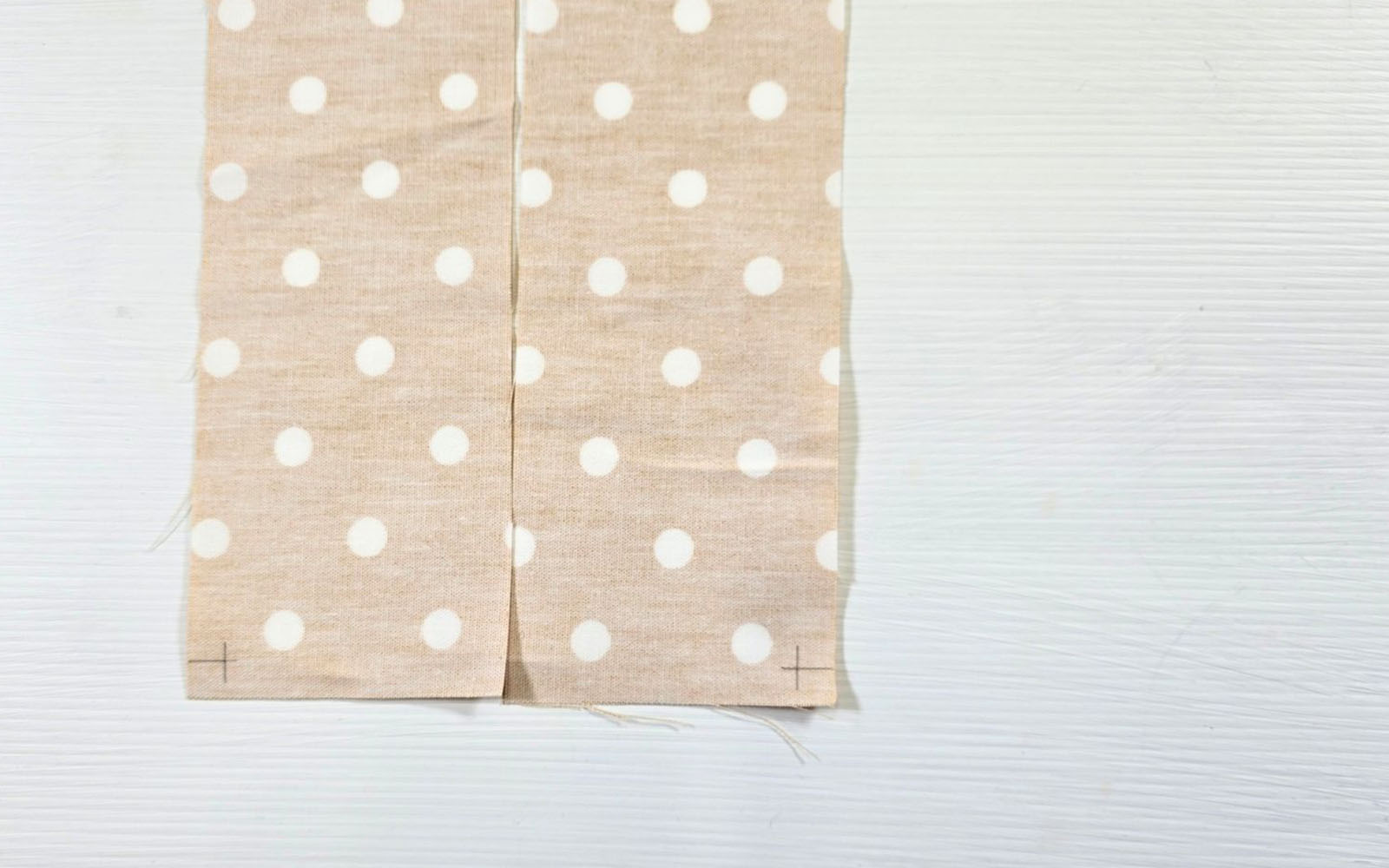 Yellow polka dot fabric strips with sewing pen marks