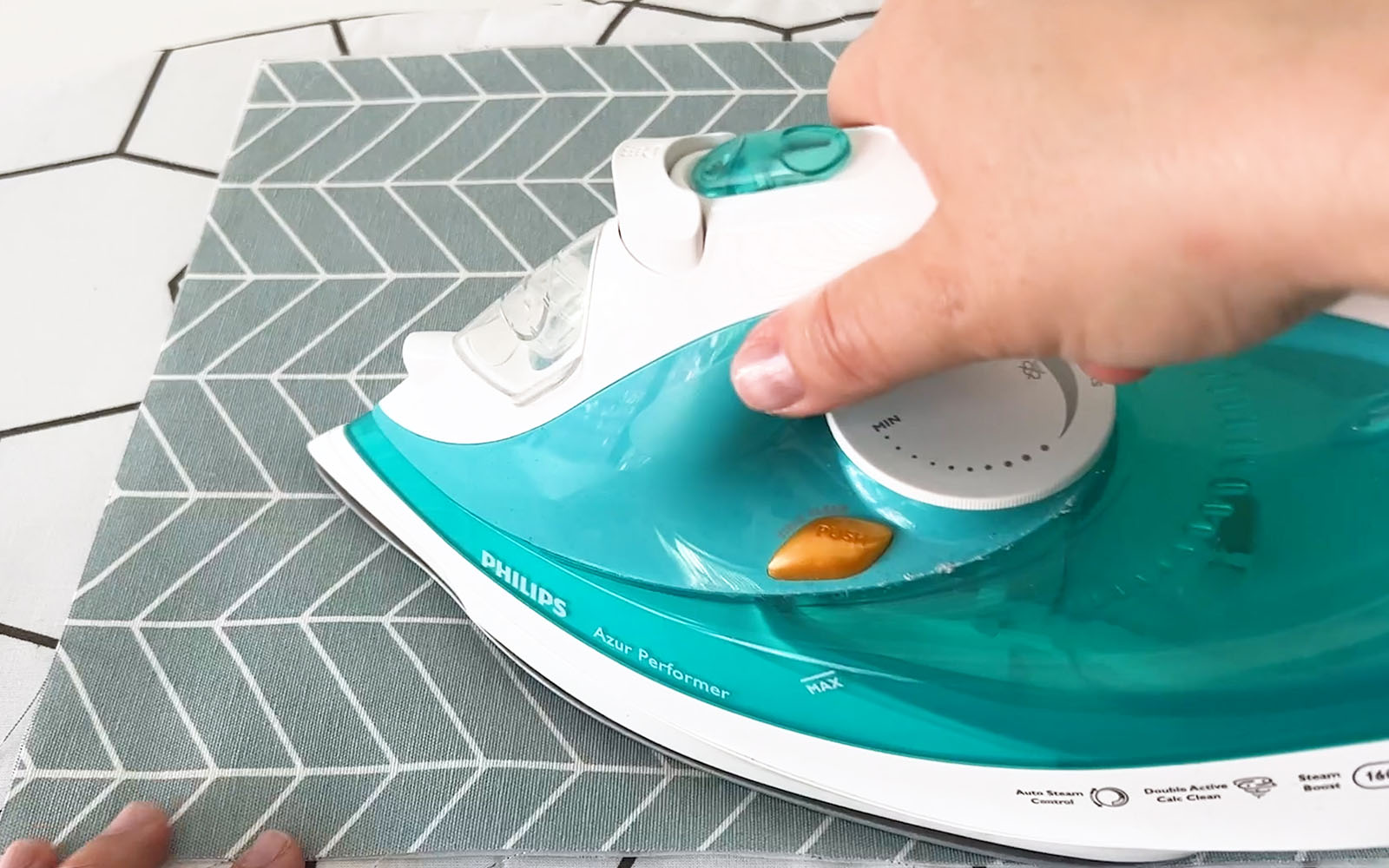 Grey and white fabric being ironed