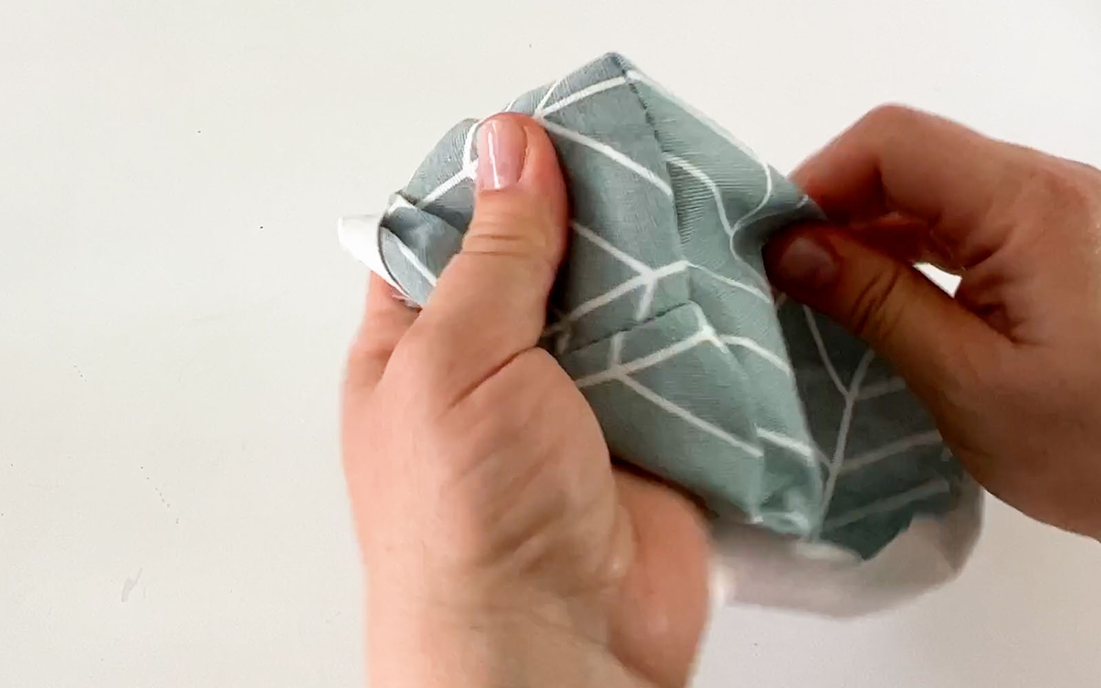 Hands turning fabric basket to right side
