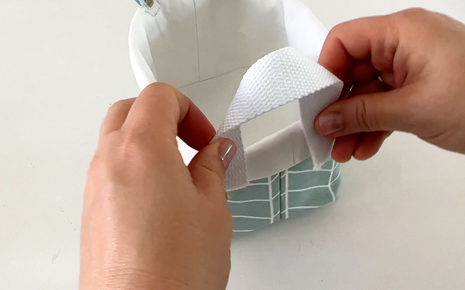 Handles being added to fabric basket