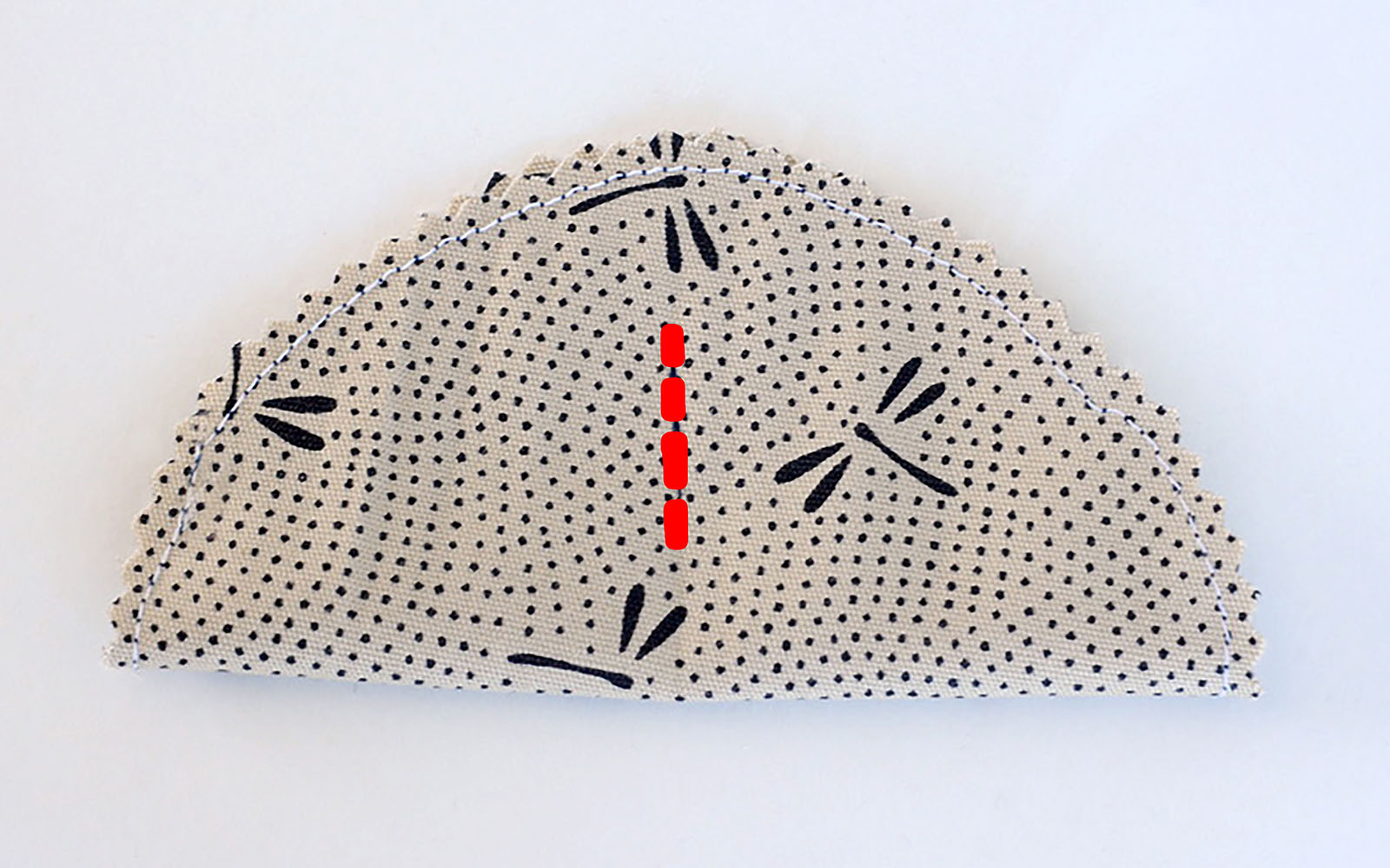 beige fabric fortune cookie with sewing line marked