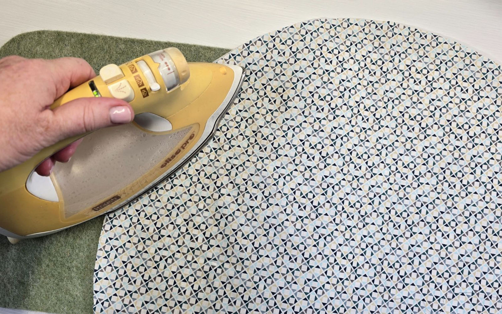 Fuse batting to the wrong side of bag lining with iron