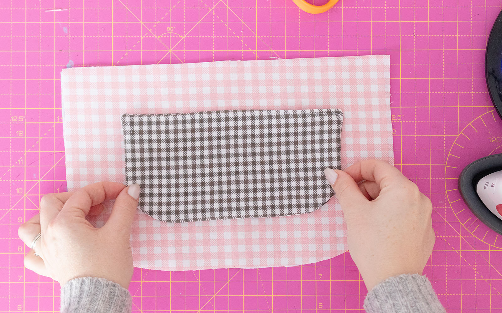 placing black gingham pocket on pink gingham bag