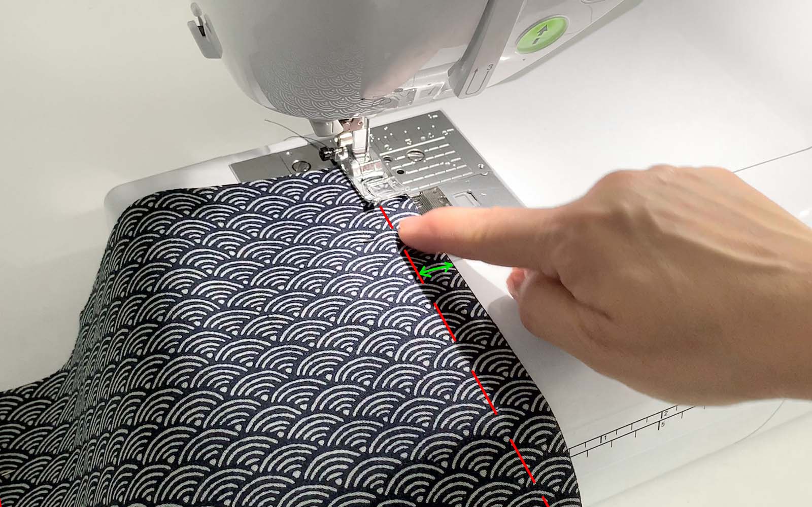 Fan pattern oilcloth in sewing machine with 1cm allowance marked