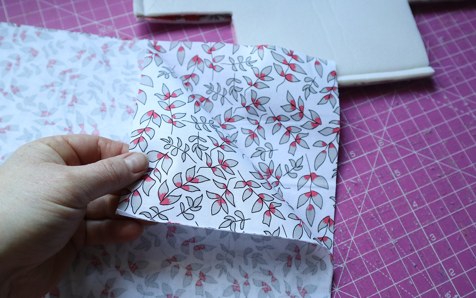 Pink leaf pattern fabric from Petal and Pip on pink cutting mat