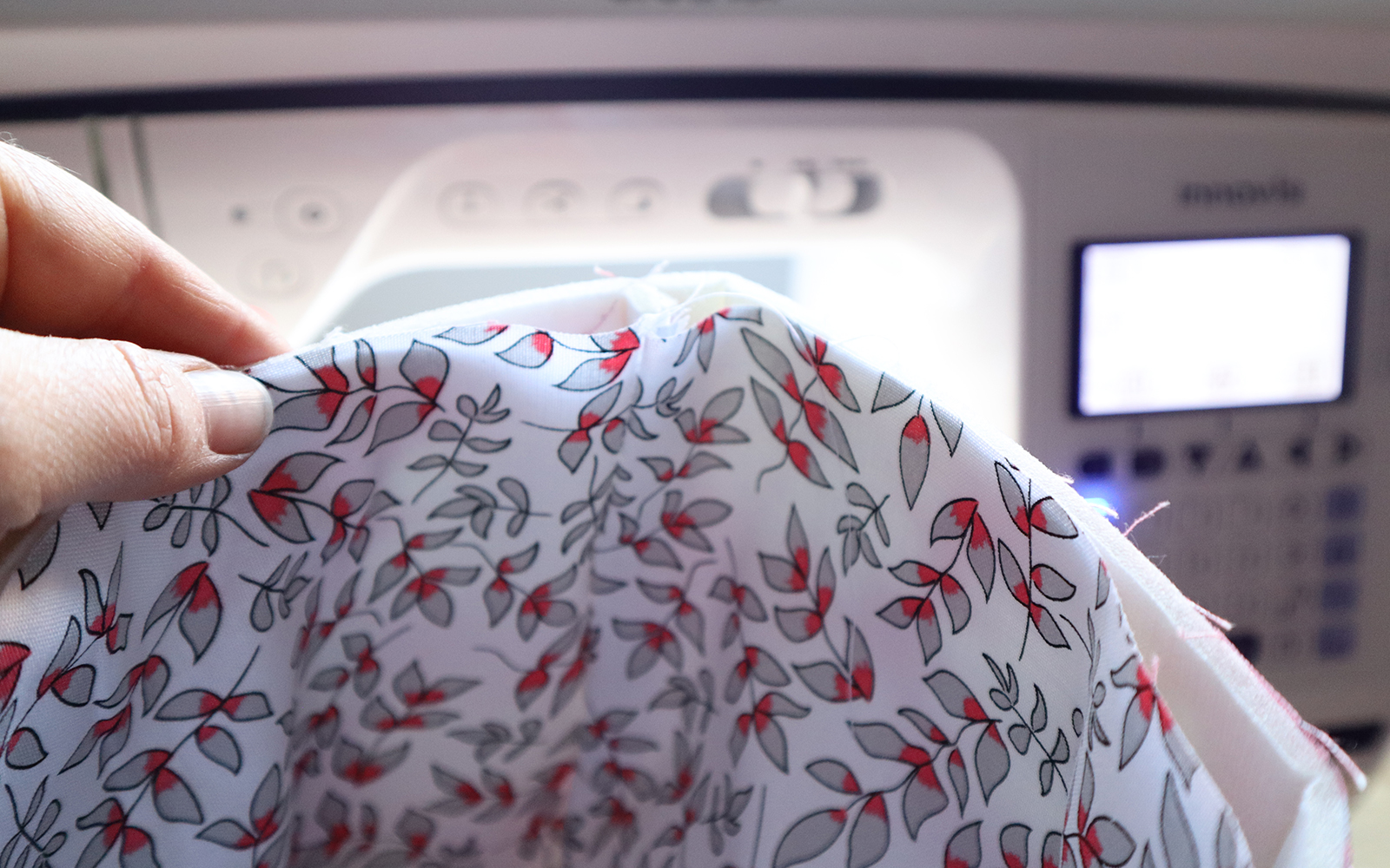 Pink leaf fabric in front of Brother NV1800Q sewing and quilting machine