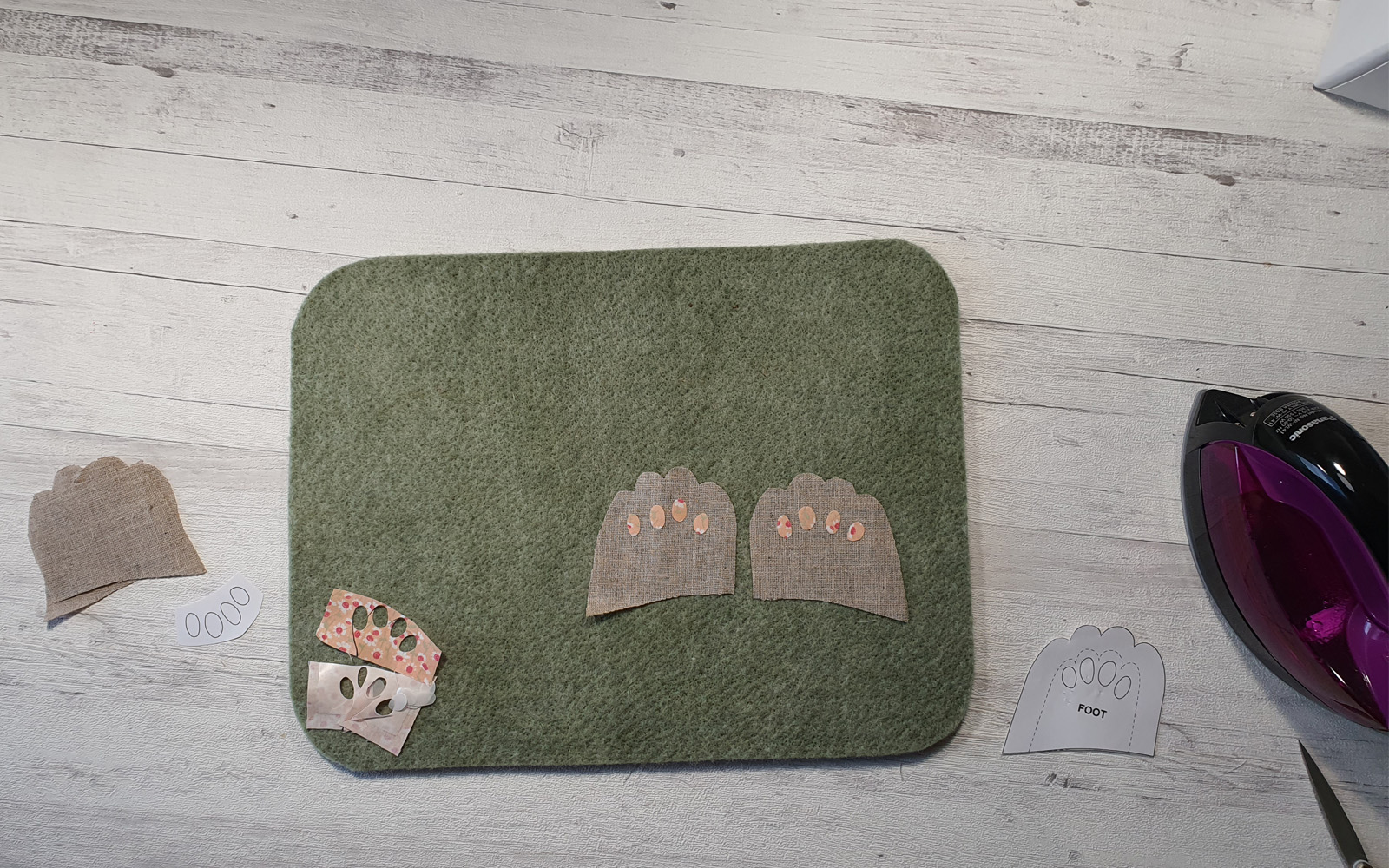 Cut out fabric for bunny paws on mat