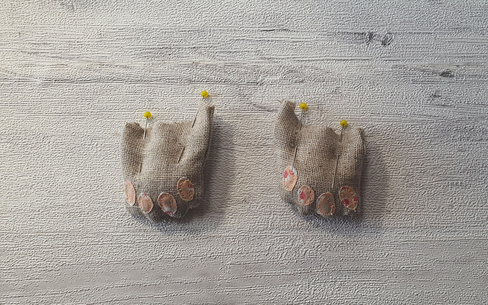fabric bunny paws on wooden background