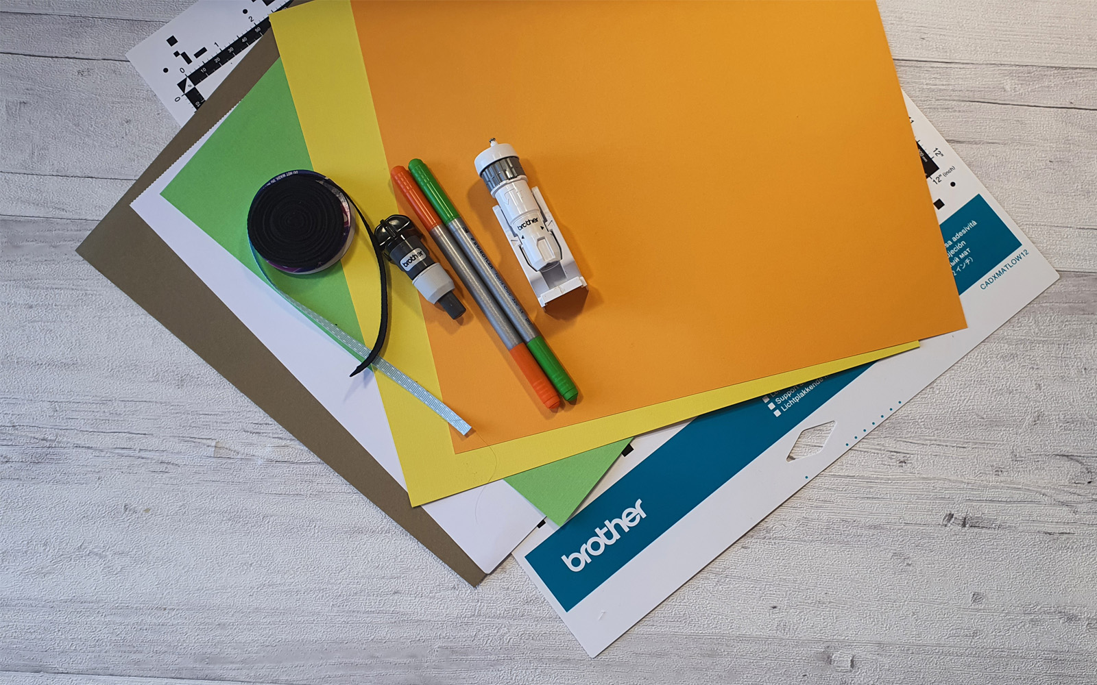coloured card stock and ScanNCut equipment on white background
