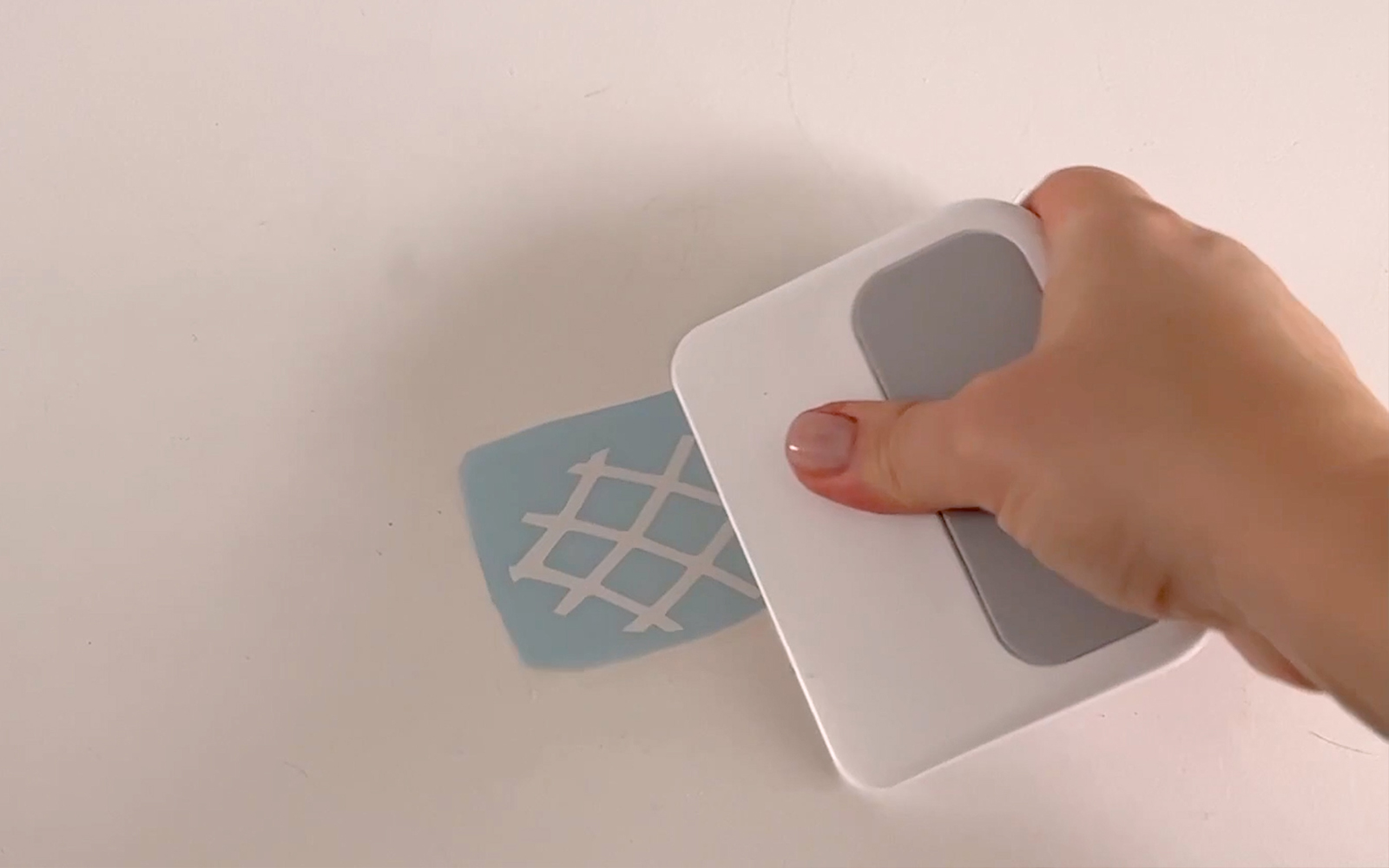 close up image of hand using Brother ScanNCut squeegee