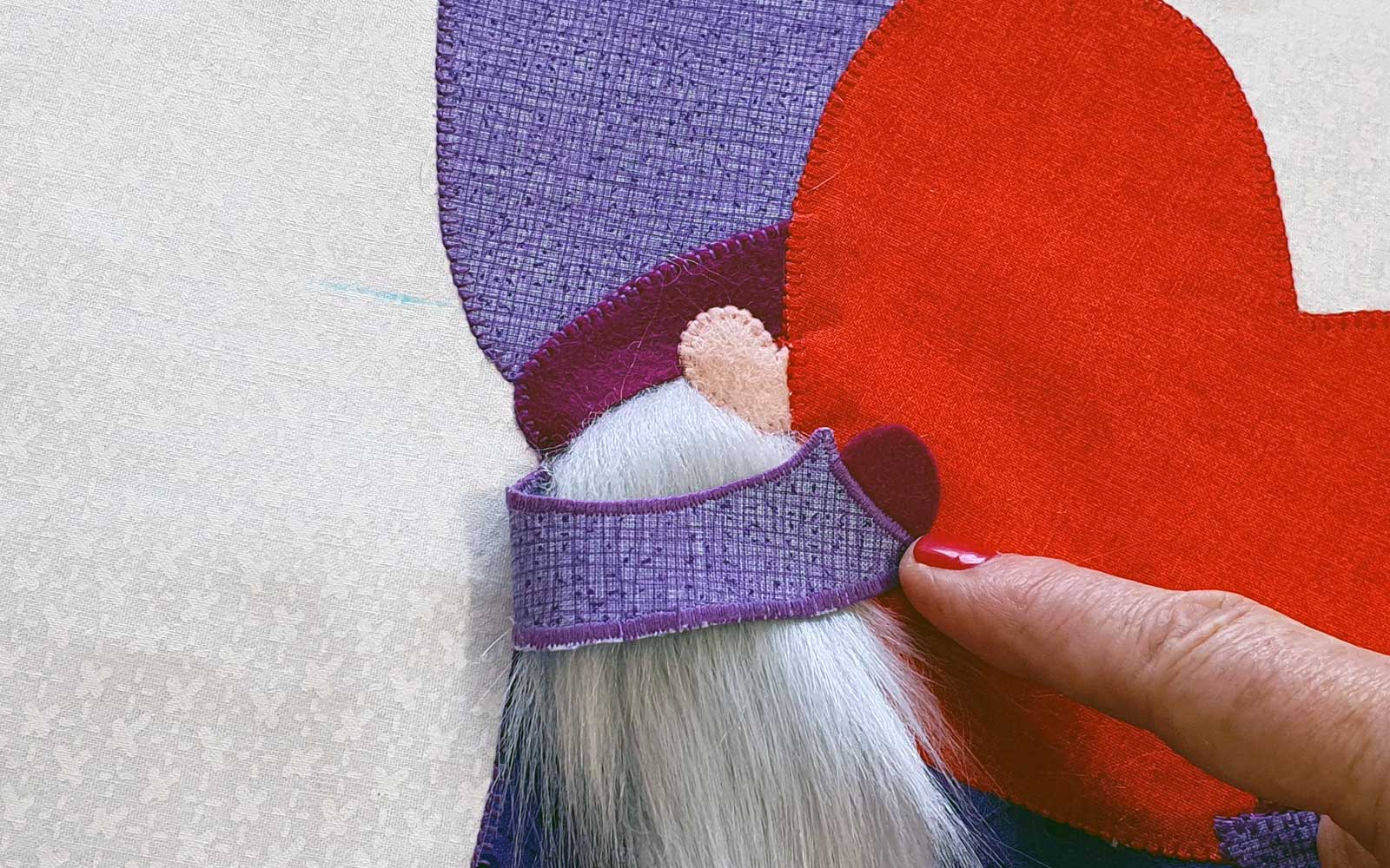 Finger folding arm backwards to show placement