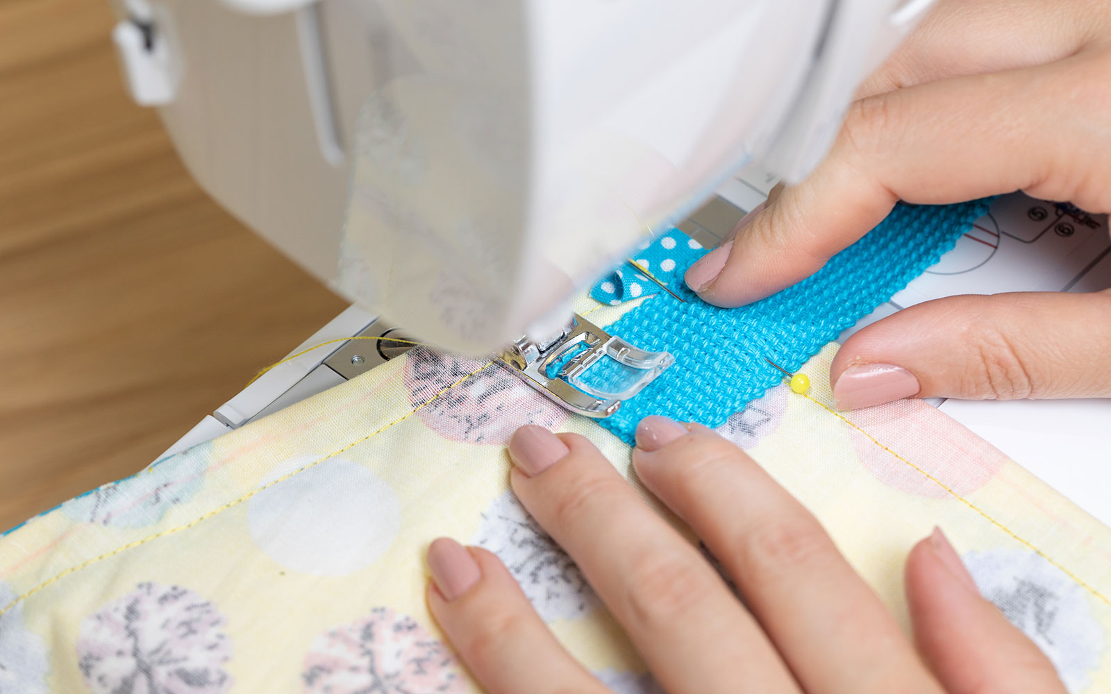 sewing blue tie to back of yellow apron