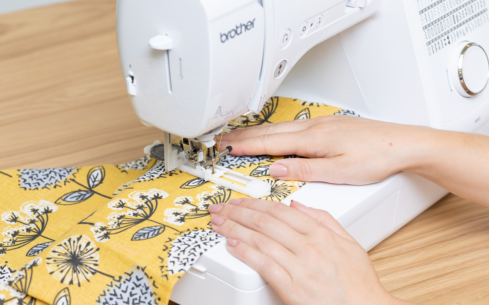 Yellow material on sewing machine with button presser foot