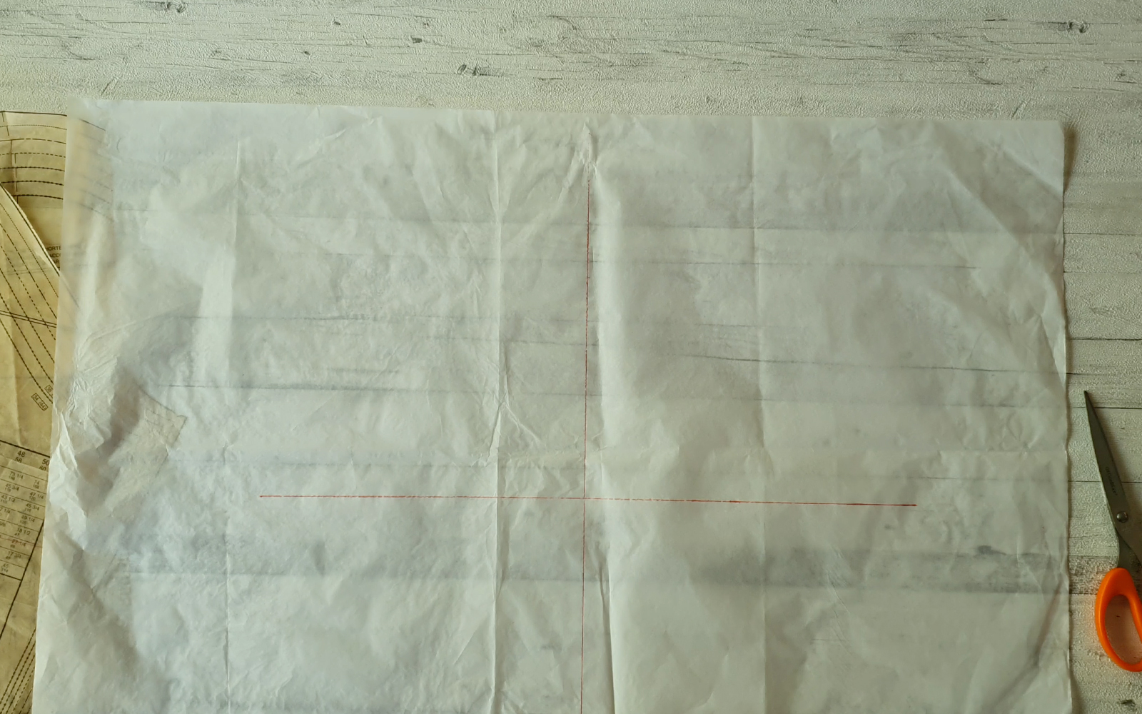 Whte pattern piece with red cross marks