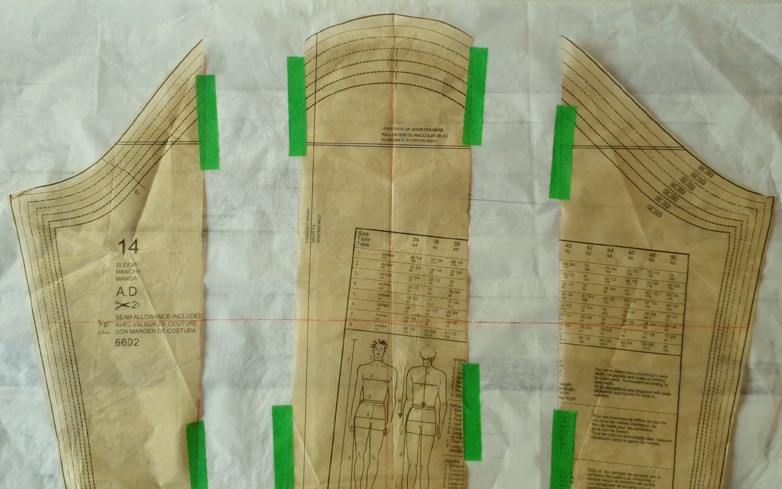 3 brown paper patterns stuck onto white sheet